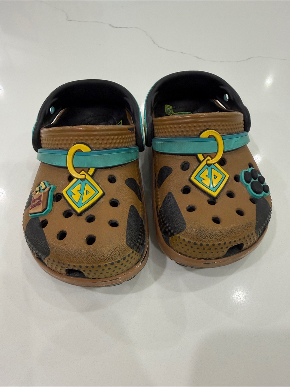 CROCS Kids Brown Clogs with Teal Strap and Yellow Charm Accents